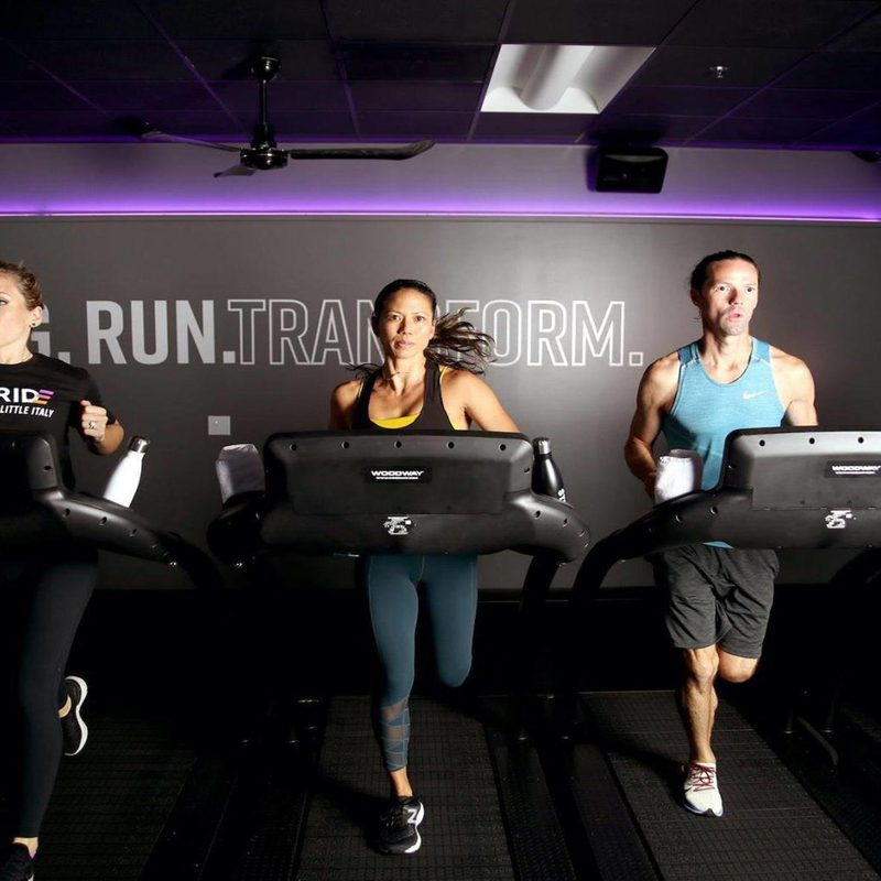 Athletes working out on treadmills at Stride Fitness