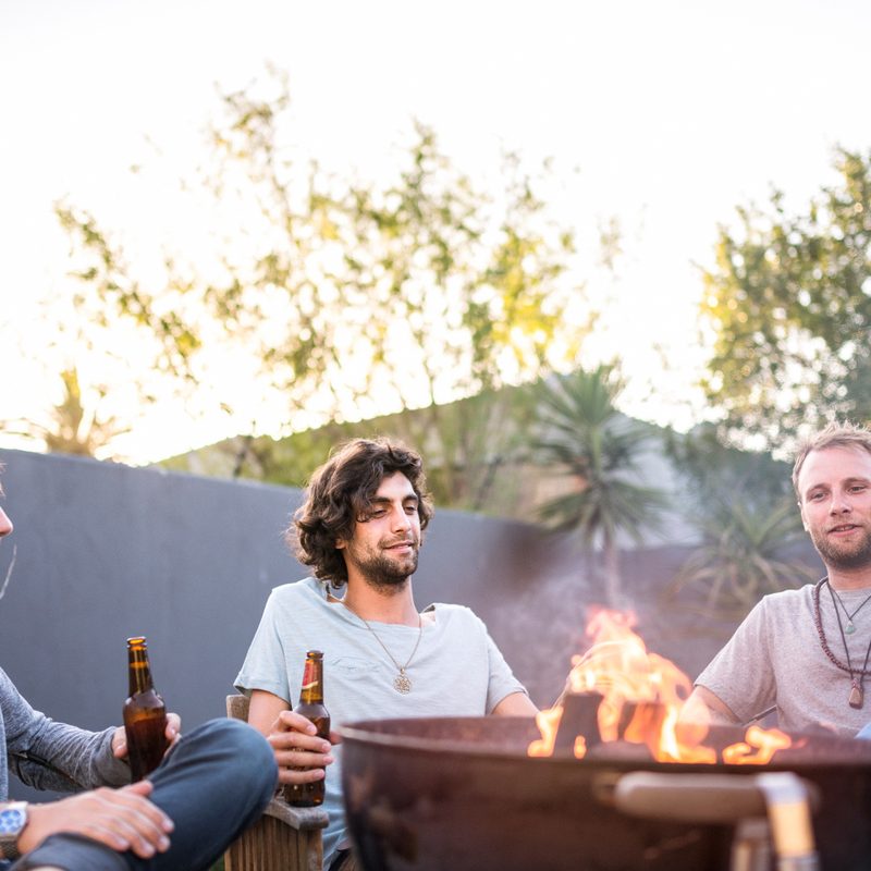 Friends garthered around a fire pit