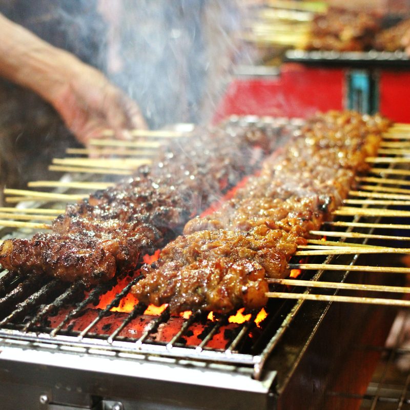 Meat skewers being grilled.