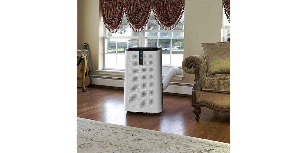 Lifestyle image of JHS 14,000 BTU Portable Air Conditioner in a living room environment.