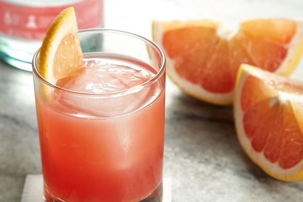 A glass of Picnic Basket Cocktail with grapefruit,