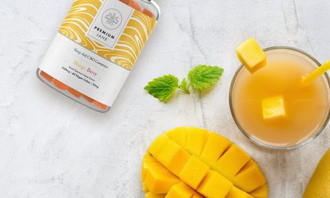 Premium Jane Mango Berry CBD Gummies with cut-up mango fruit.