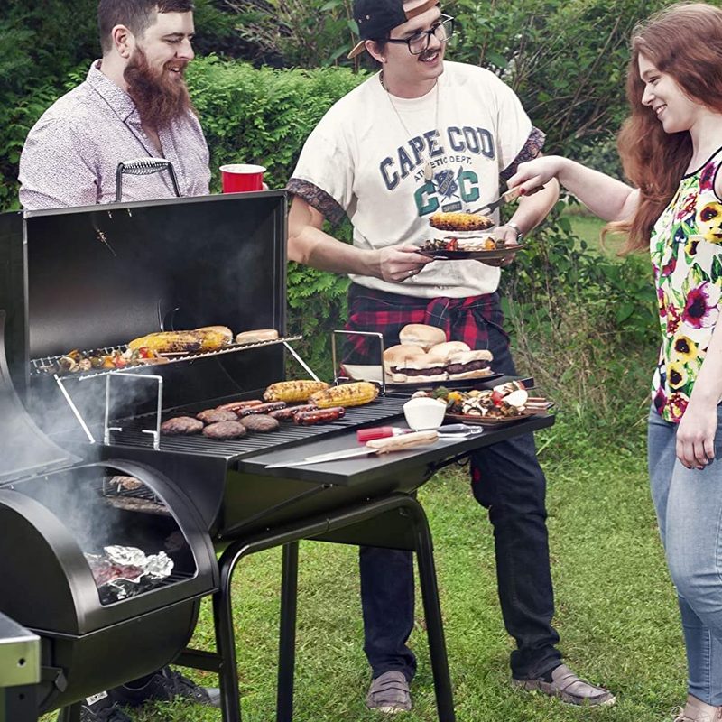 Two men and a woman grilling burgers and corn on a Royal Gourmet Charcoal Grill with Offset Smoker.