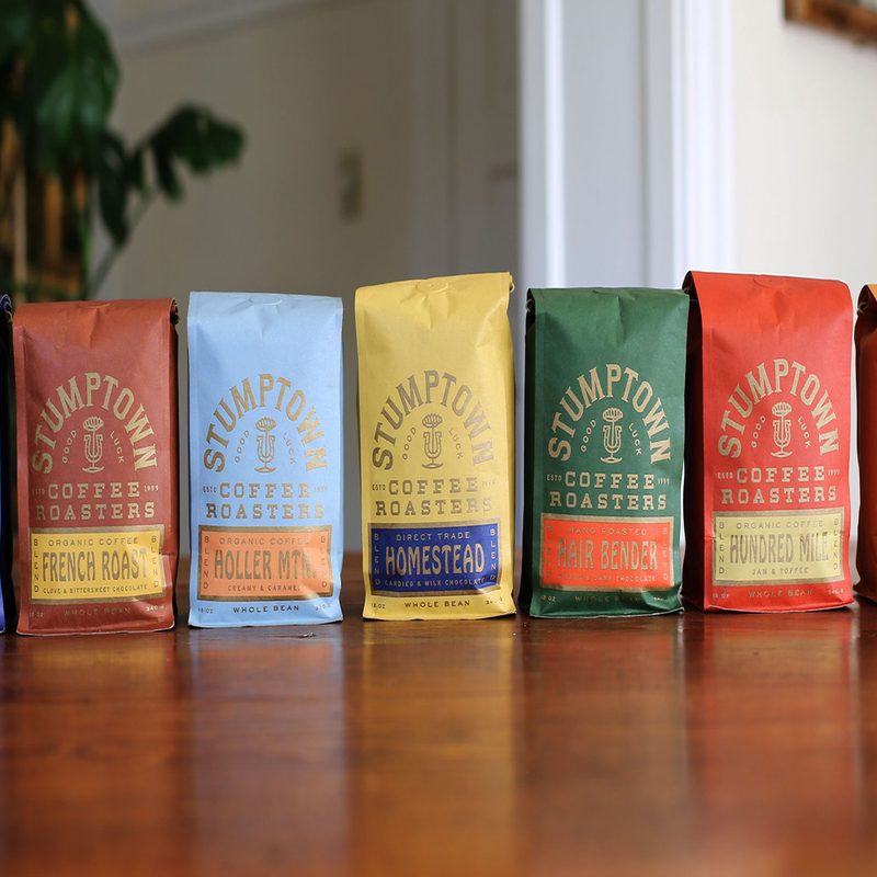 Assorted bags of coffee blends from Stumptown Coffee Roasters displayed on the table.