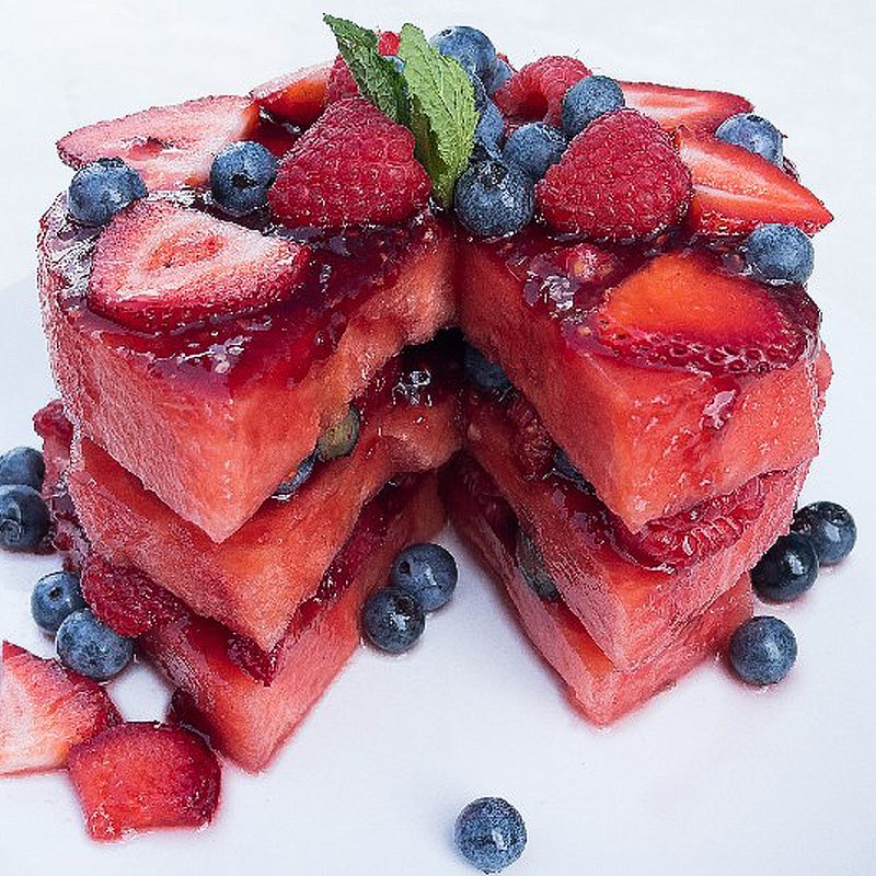 Slices of watermelon cake with berries.