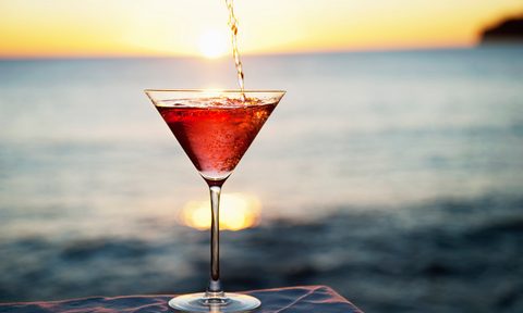 Cocktail pouring in glass outdoors