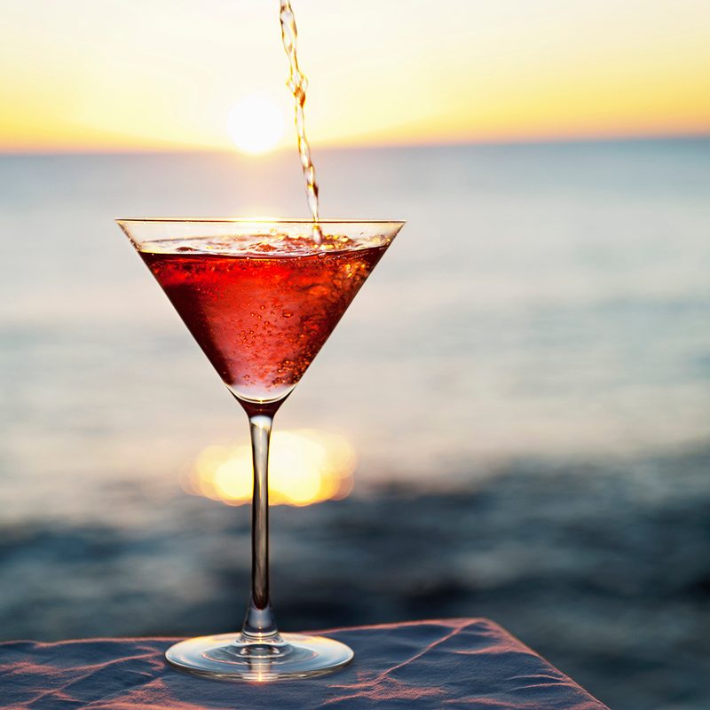 Cocktail pouring in glass outdoors