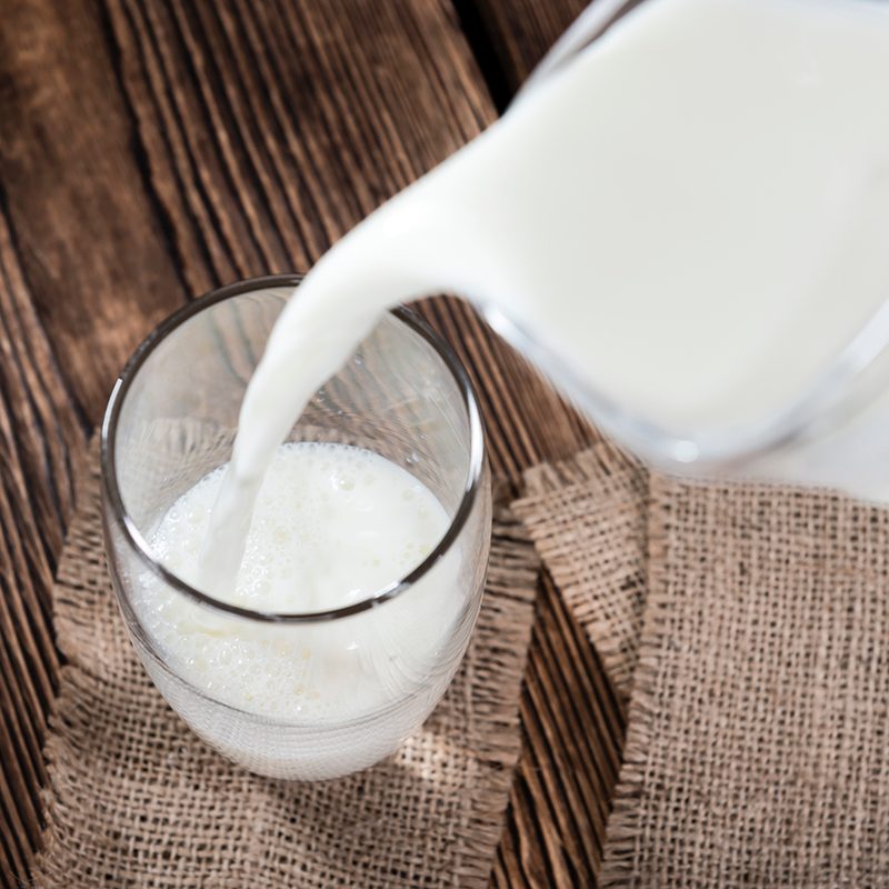 A portion of Milk on a dark wooden background.