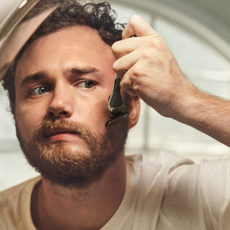 A man shaving his face.