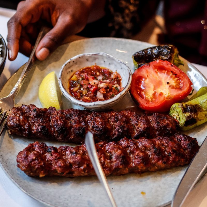 Turkish Adana kebab plate with grilled vegetables