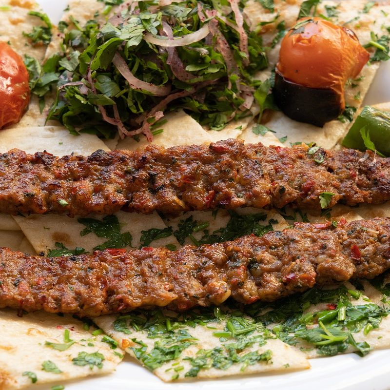 Turkish Adana kebabs over flatbread