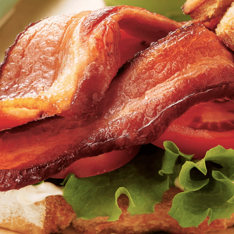 A close-up of Allen Brothers' steak-cut button with lettuce, tomato, mayonnaise, and bread.
