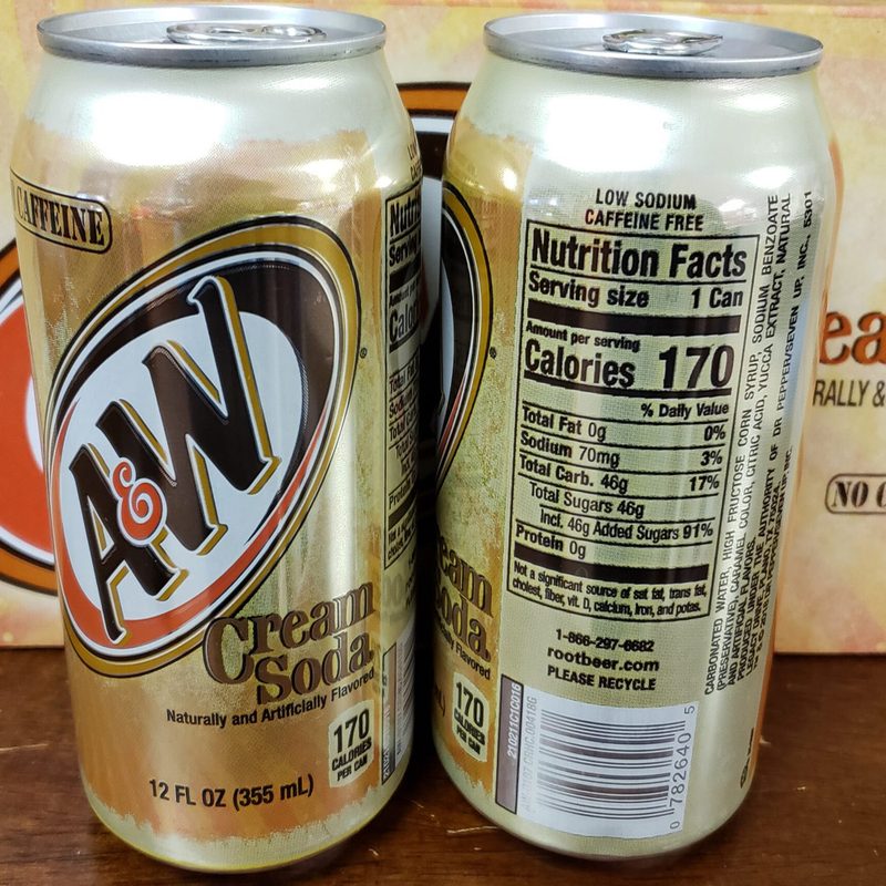 Two cans of A&W Cream Soda in front of their packaging.