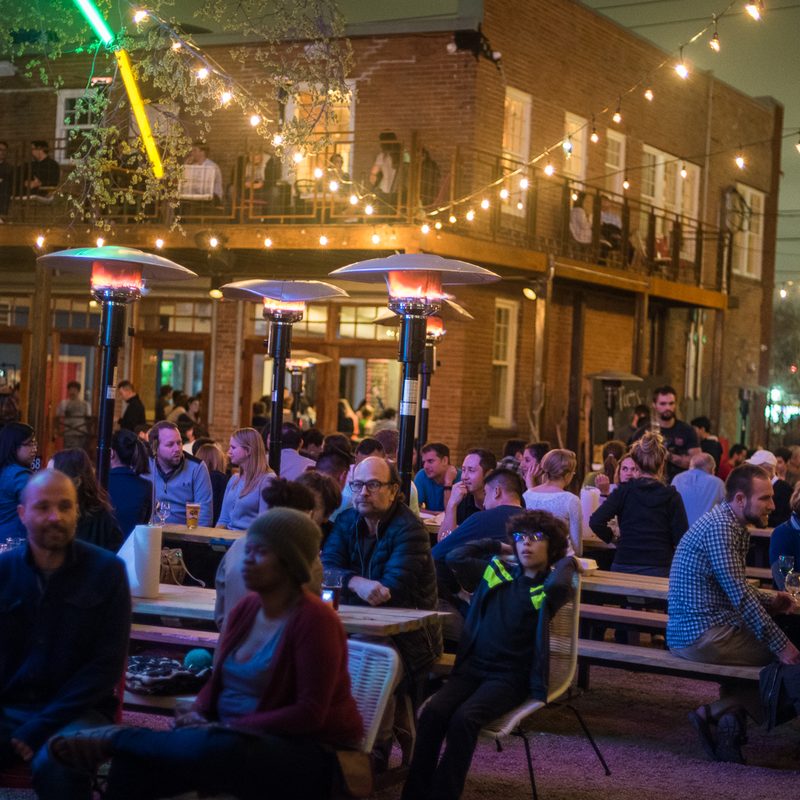 Axelrad Beer Garden in Houston filled with people hanging out.