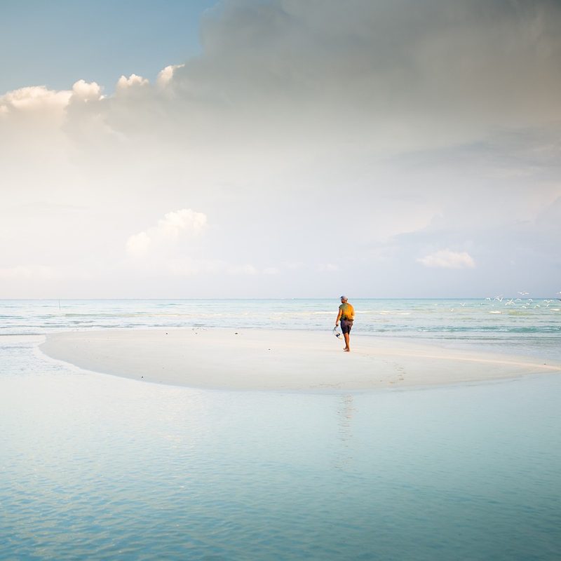 Man walking on beach.