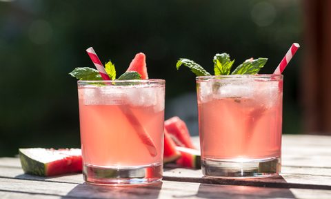 Two thirst-quenching glasses of watermelon cocktails on a wooden table.