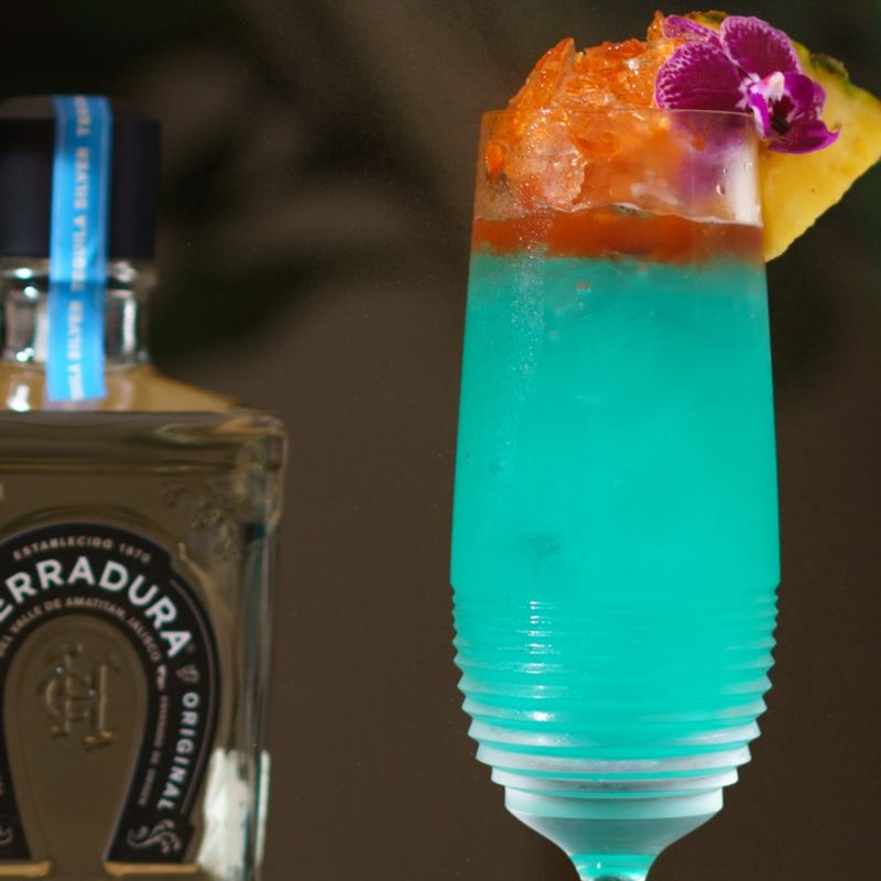 Blue Cenote Cocktail with garnish.
