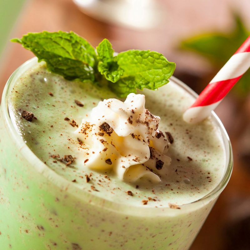 Garnished boozy shamrock shake with a straw.
