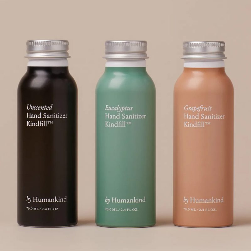Three bottles of By Humankind bottles on pink background.