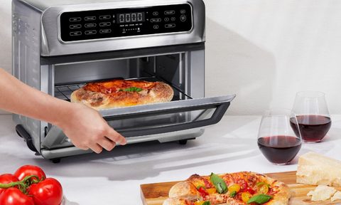 Chefman Toast-Air Dual-Function 20L Air Fryer with pizza on counter.