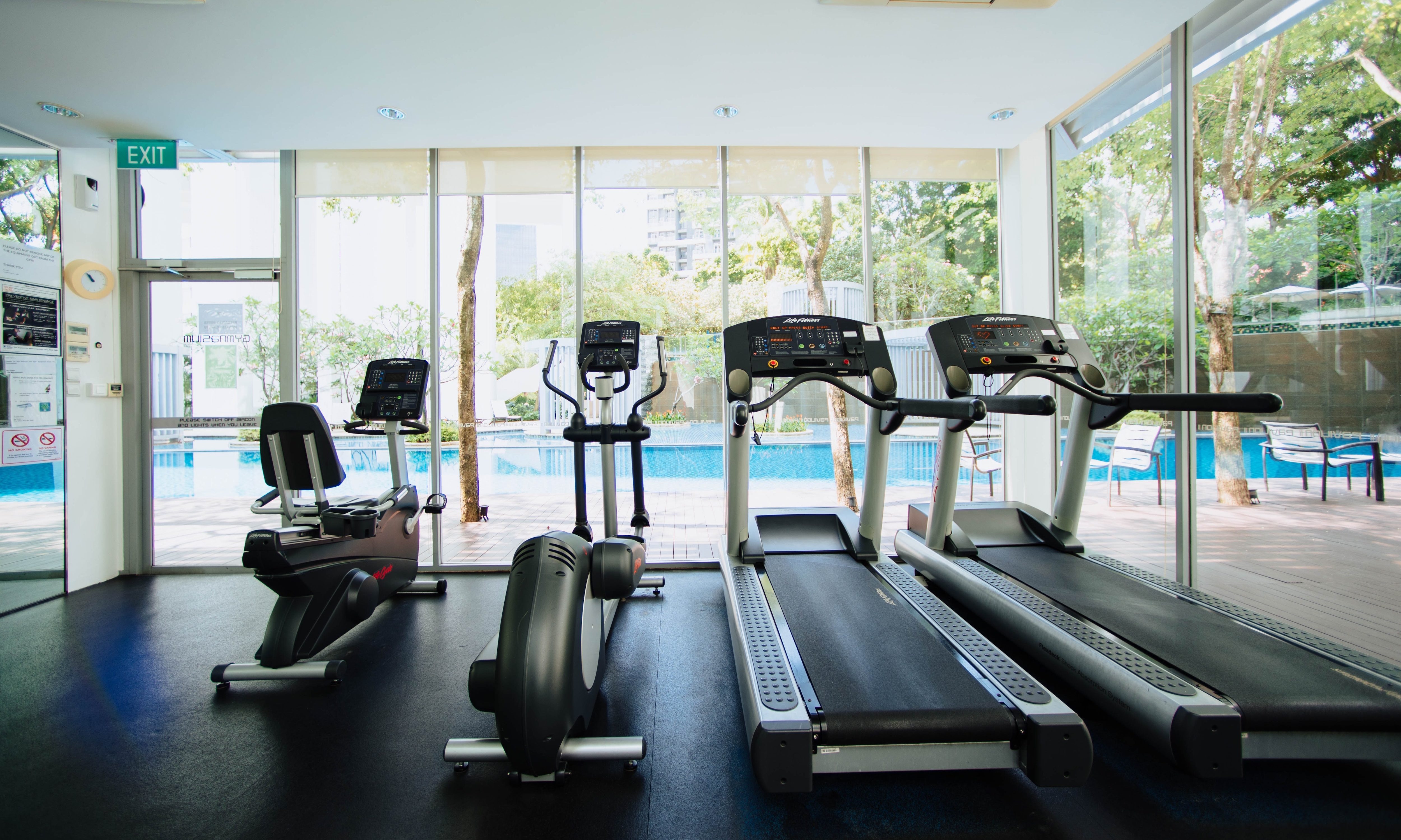 Ellptical, treadmill, and bike at a gym.