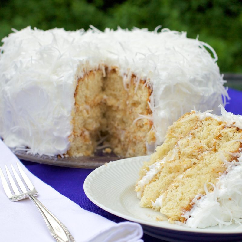 Sliced coconut cake served on a plate.
