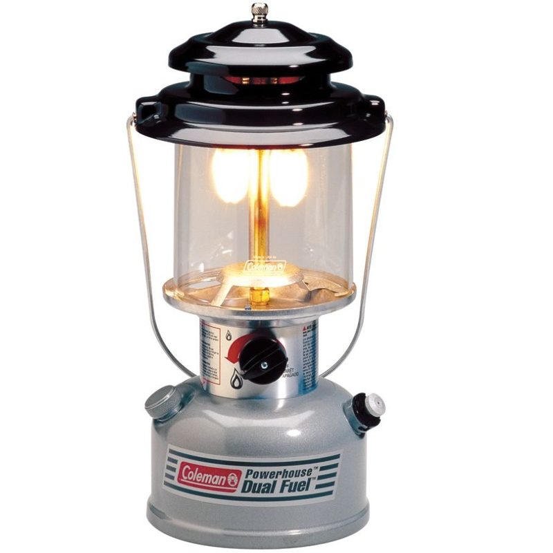 An illuminated Coleman Powerhouse Dual Fuel Lantern.