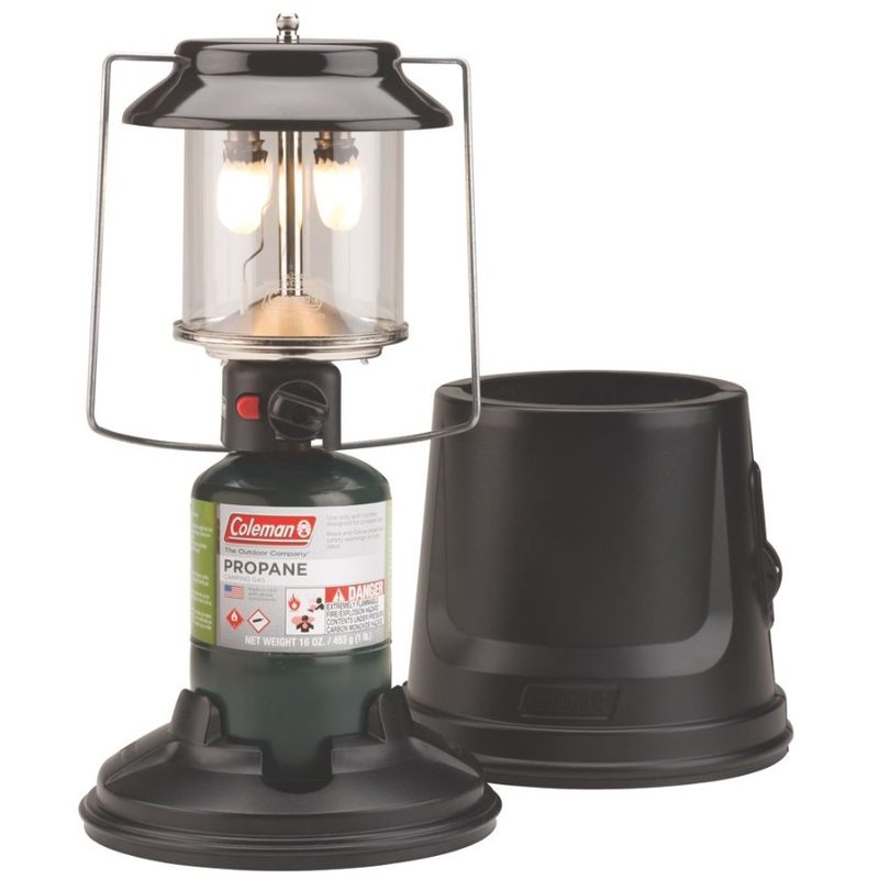 An illuminated Coleman QuickPack Propane Lantern and its carrying case on white background.