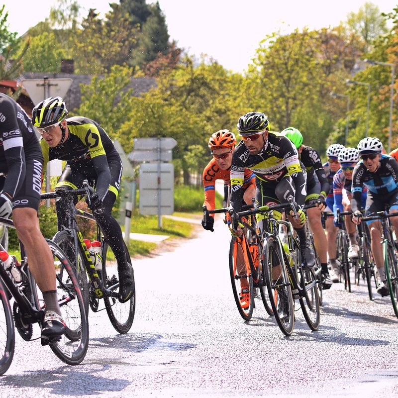 Group of men cycling on a road