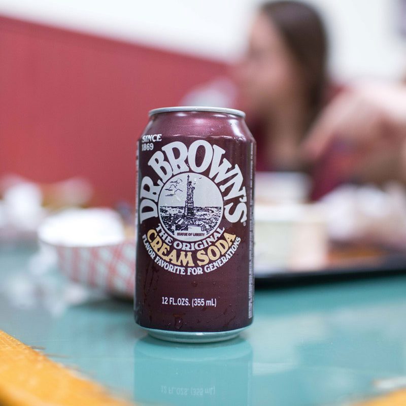 A can of Dr. Brown's The Original Cream Soda on a table in a restaurant.