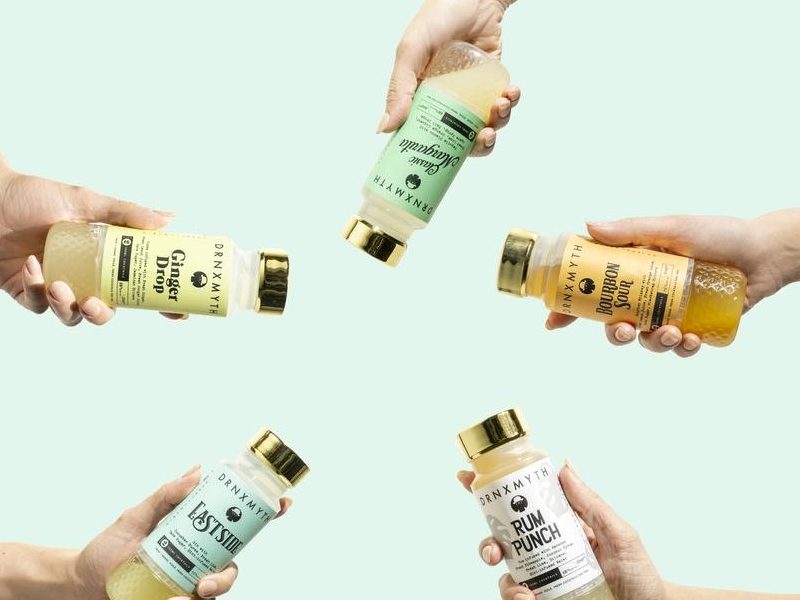Five hands holding out different flavors of pre-made cocktails.
