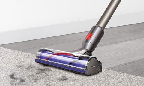 Dyson V8 Motorhead Cordless Vacuum cleaning hair off a carpet.
