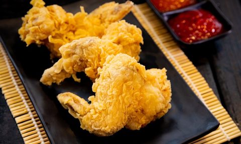 crispy fired chicken on a black napkin.