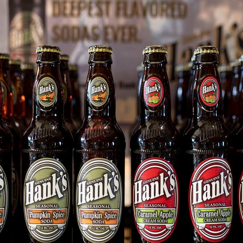 Bottles of Hank's soda displayed in a grocery store.