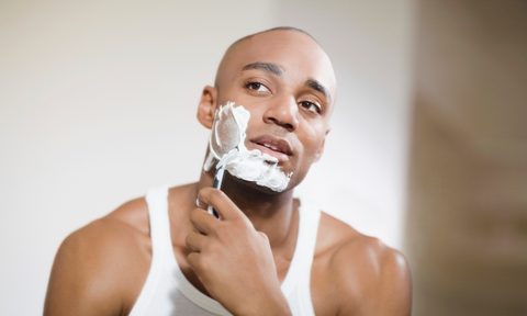 Man shaving his face with safety razor