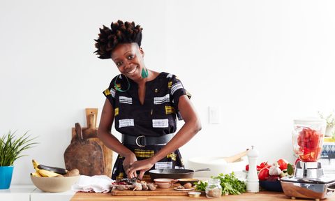 Yewande Komolafe of NYT Cooking happily prepares a dish.