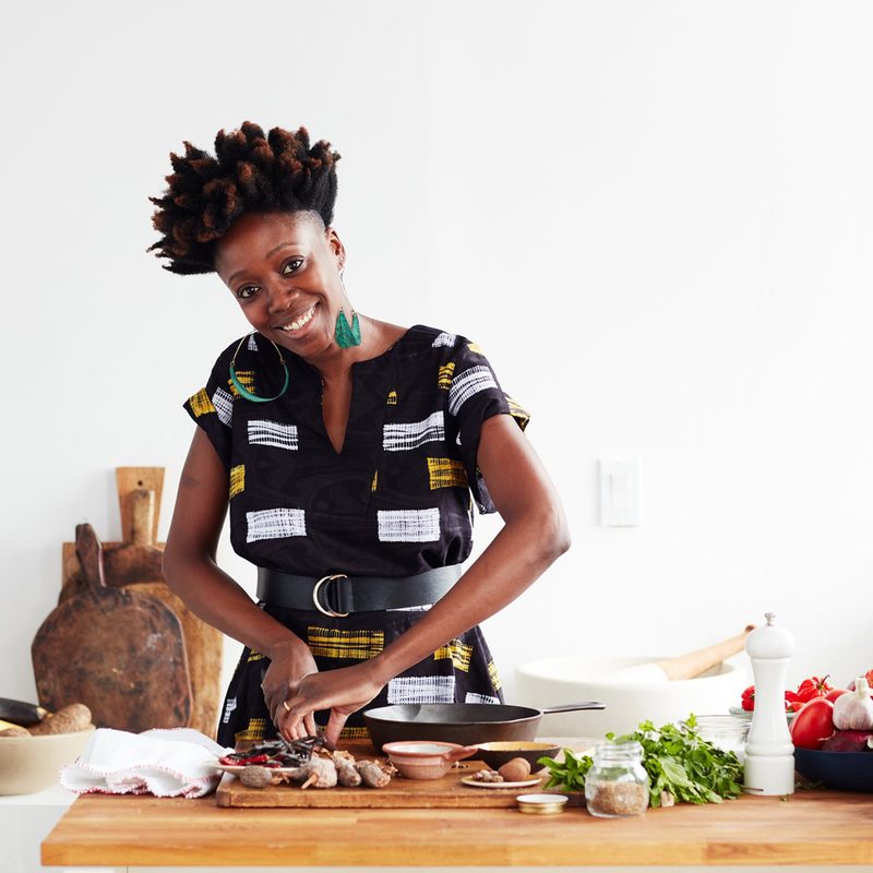 Yewande Komolafe of NYT Cooking happily prepares a dish.