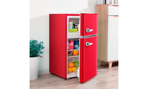 Insignia Retro 3.1 cubic feet Mini Fridge placed in a kitchen with a plant pot next to it.