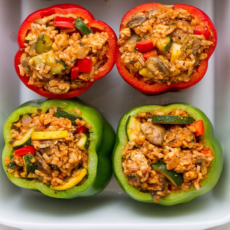 Four rolls of Italian vegan stuffed peppers in a white tray.