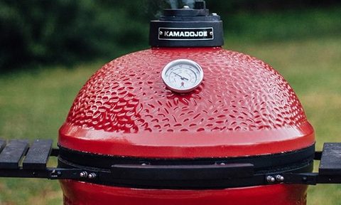 Kamado Joe Classic grill smoking out of the top.