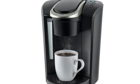 Keurig K-Select Single-Serve Maker with standard mug and brewed coffee.