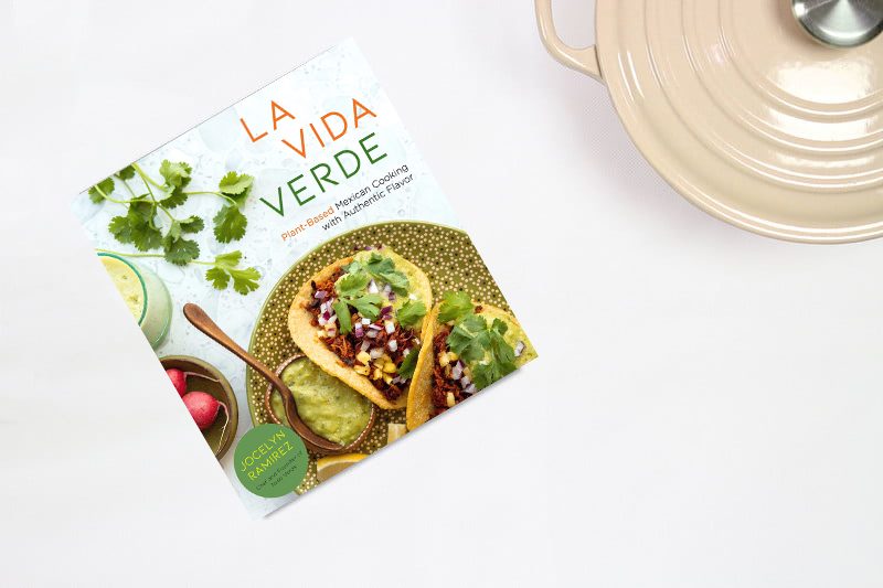La Vida Verde cookbook on table next to dutch oven.