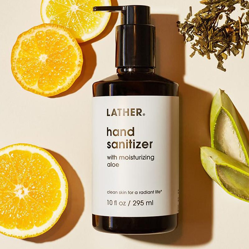 Lather Hand Sanitizer moisturizing aloe with lemons on background.