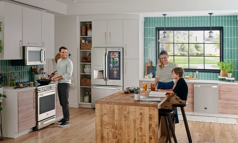 LG Studio Appliances in a kitchen with family members.