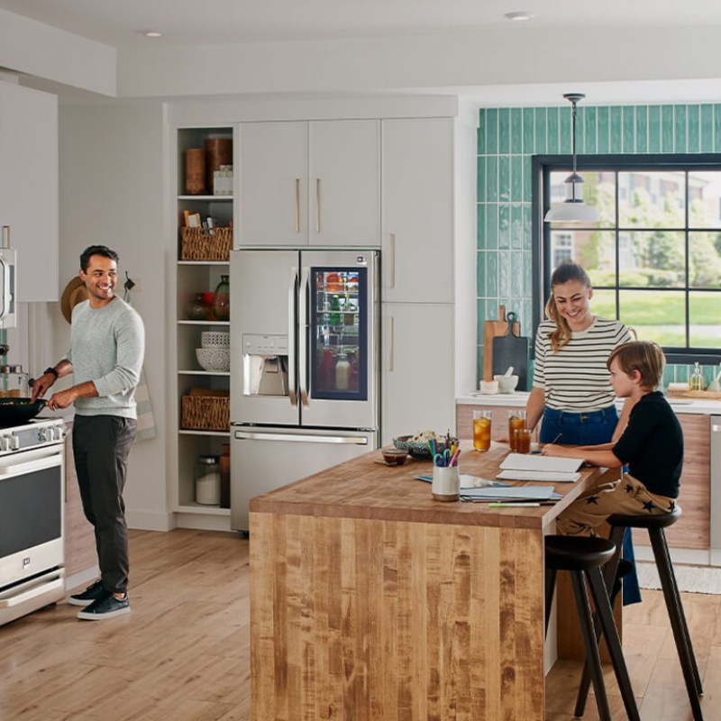 LG Studio Appliances in a kitchen with family members.