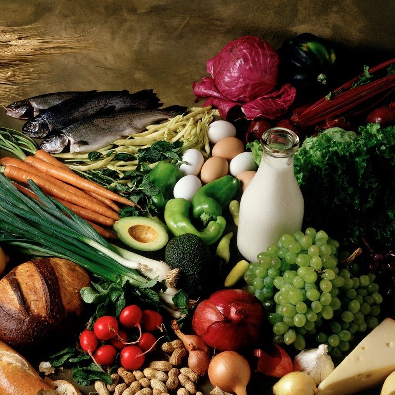 A wide assortment of foods, from bread, dairy, nuts, and eggs to cheese, fruits, and vegetables.