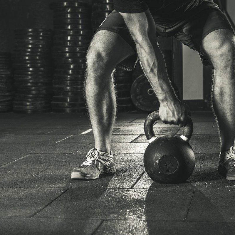 Kettlebell training in gym.