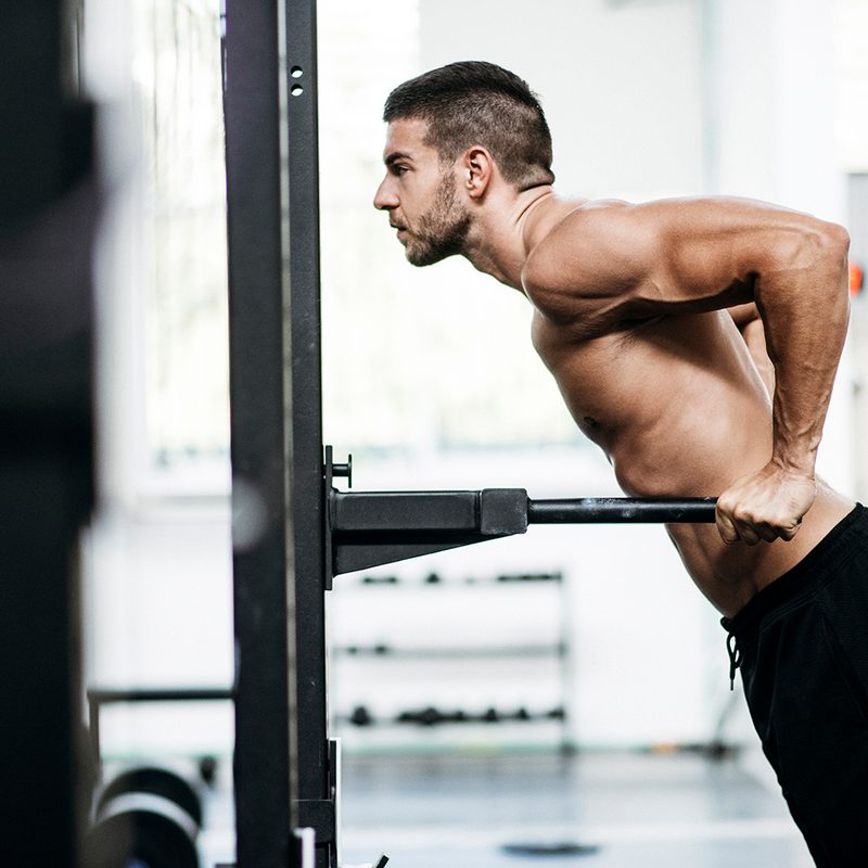 Man doing a dip at the gym.