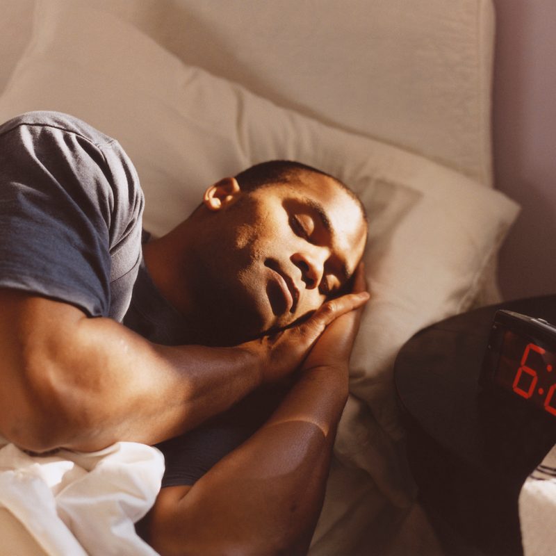 Man sleeping soundly in his bed