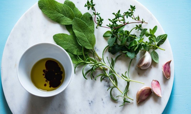 Oil and vinegar with herbs for a marinade